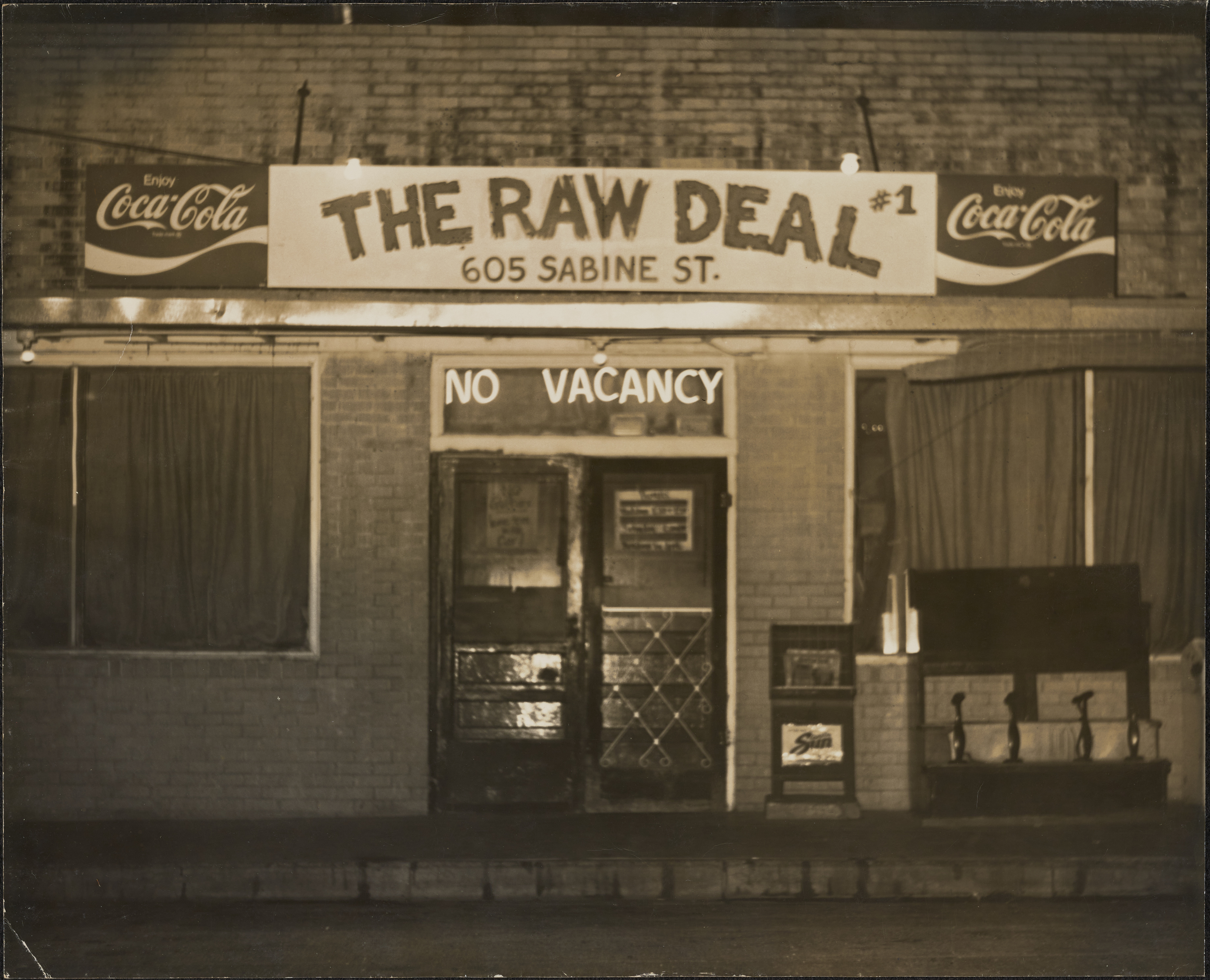 Image of exterior front door of The Raw Deal restaurant and bar.