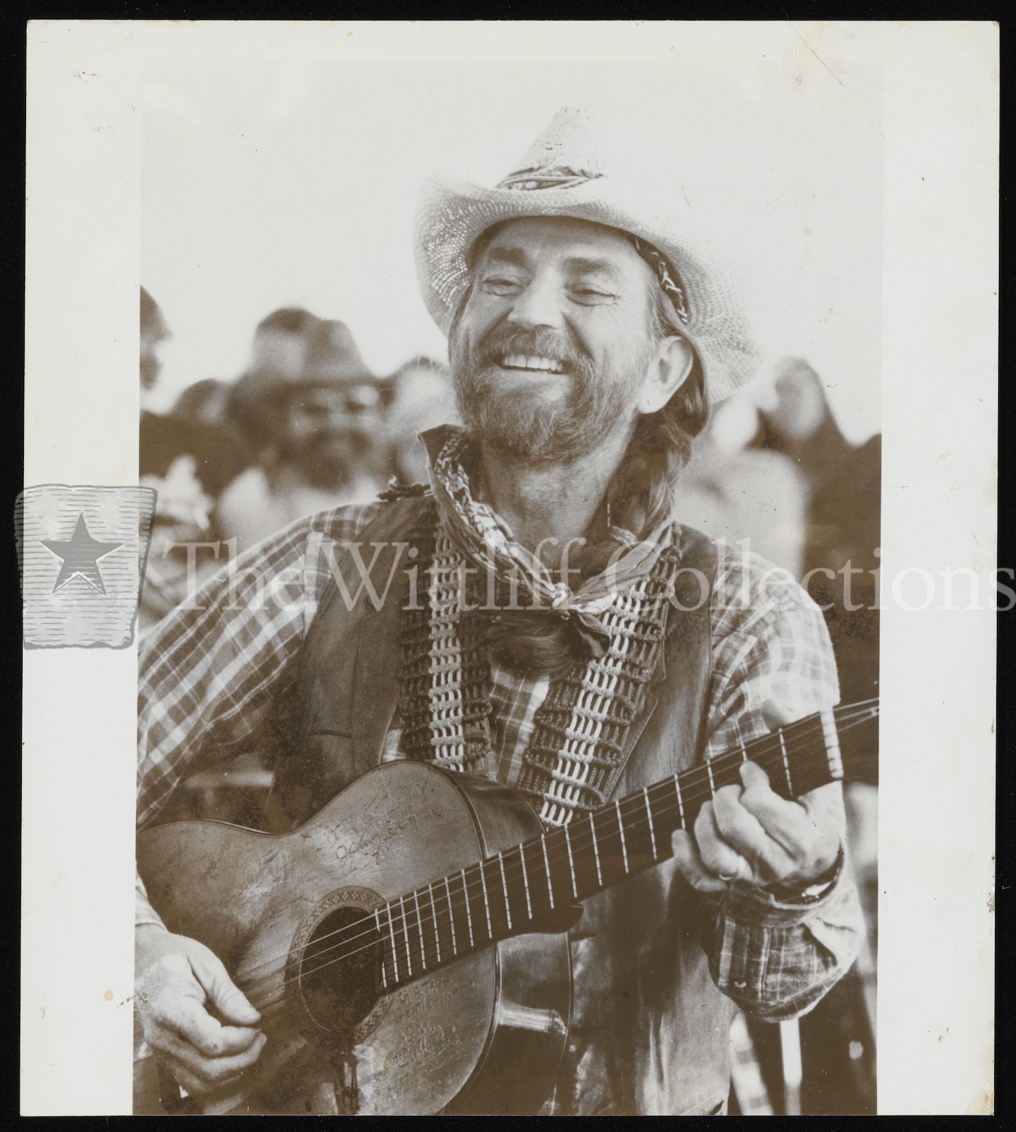Nelson smiling with guitar