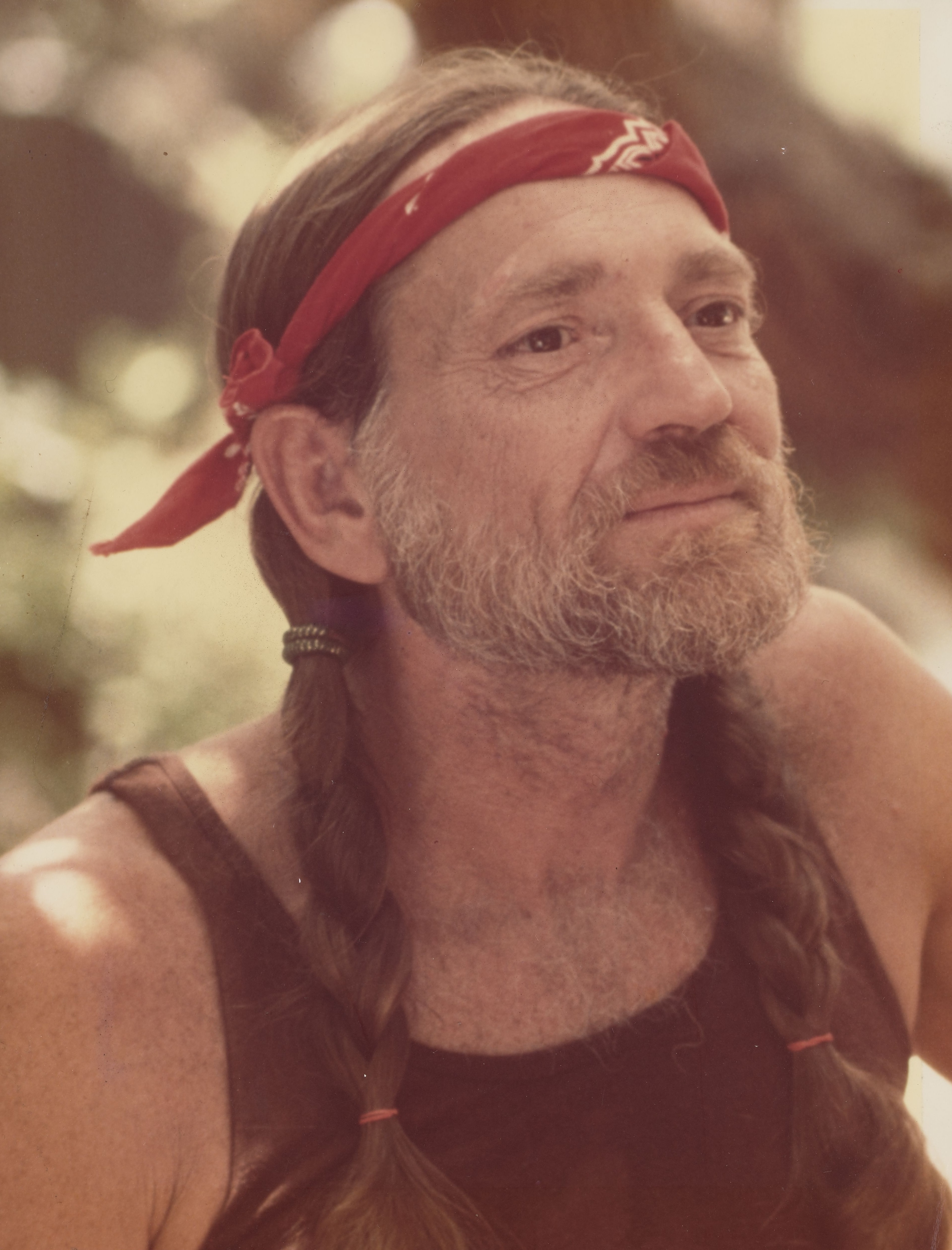 Image of Willie Nelson with a red headband on
